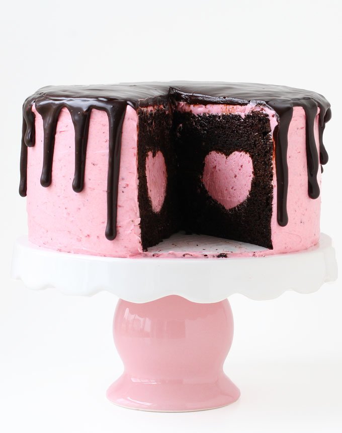 Cut into this pretty pink cake to reveal a strawberry cheesecake heart hiding inside a rich and decadent chocolate cake. This Strawberry Cheesecake Heart Surprise Cake will make Valentine's Day even more special.