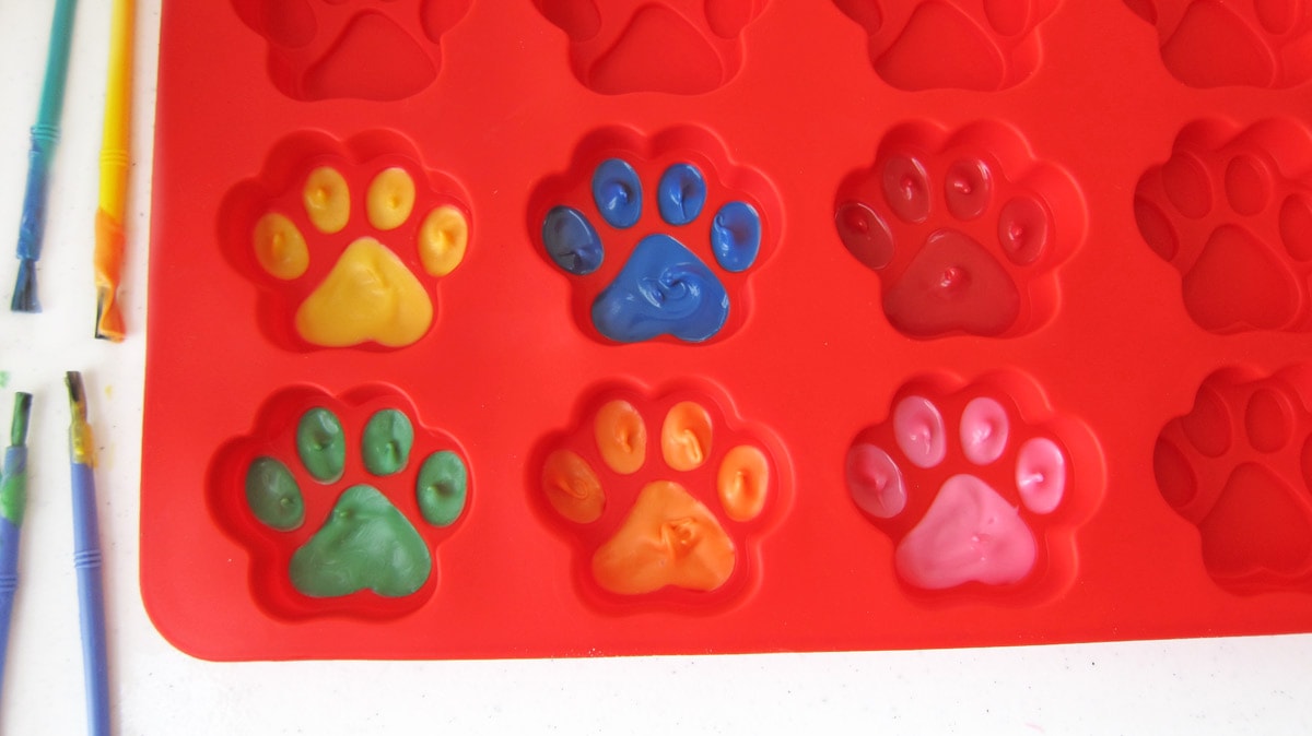 silicone paw mold painted with yellow, green, blue, orange, red, and pink paws.