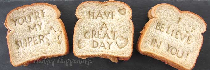 pb&j sandwiches imprinted with special messages like "You're my super star," "Have a great day," and "I believe in you!"
