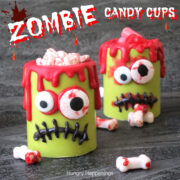 zombie candy cups made with vibrant green, red, and black candy melts and bloodshot candy eyes.