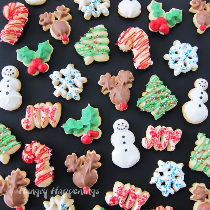 Candy Cane, Rudolph, Snowman, Christmas Tree, Snowflake, Holly Leaves, and Joy Spritz Cookies for Christmas.