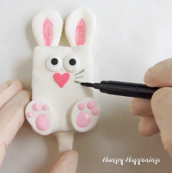 draw whiskers on cereal treat bunny using black food coloring marker