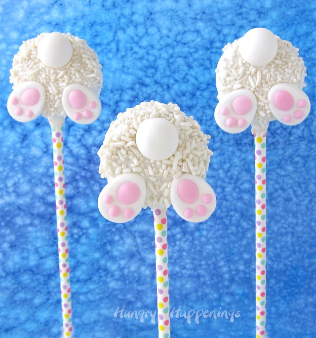 white chocolate-dipped OREO cookies coated in white sprinkles and decorated with a candy tail and paws to look like a bunny butt