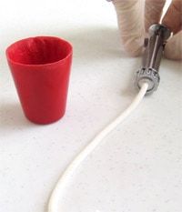 How to use a clay extruder with modeling chocolate to make a rim for an edible red cup. 