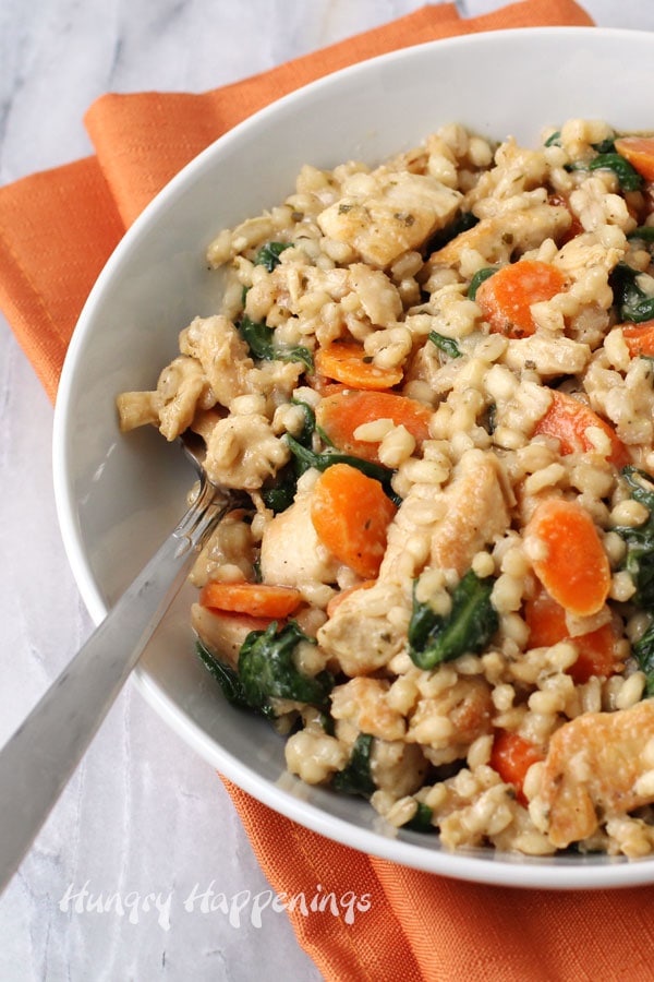 Easy lemon chicken with barley, carrots, and spinach can be made in one skillet.
