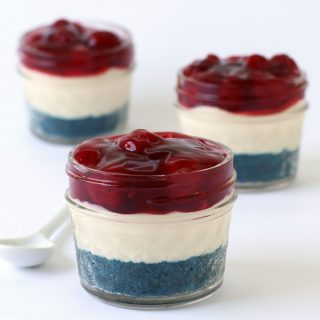 Red, white and blue no-bake cheesecakes in mini mason jars
