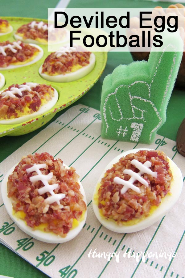 Deviled Egg Footballs on a game day tablescape featuring a foam finger and a football field napkin.