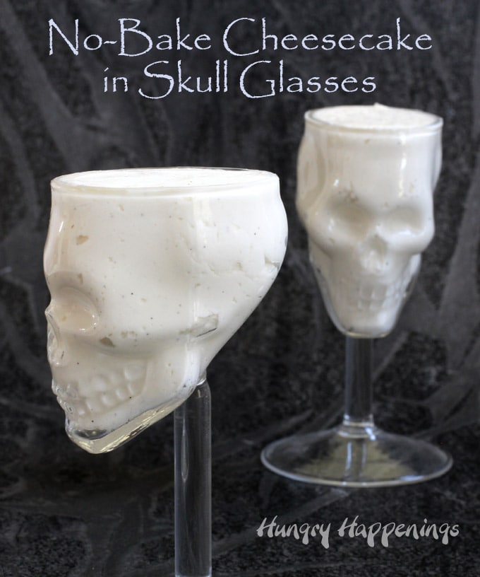 a side view of the skull shaped wine glasses filled with cheesecake mousse