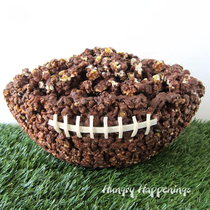 Chocolate Popcorn Bowl Football set on astro turf on a white background.