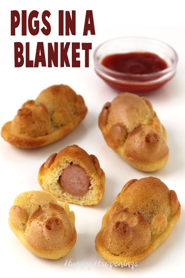 Pig shaped pigs in a blanket served with ketchup.