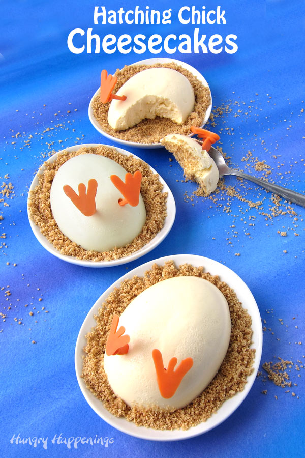 vertical image of three Hatching Chick Cheesecakes on oval plates. One cheesecake has a spoonful removed. 