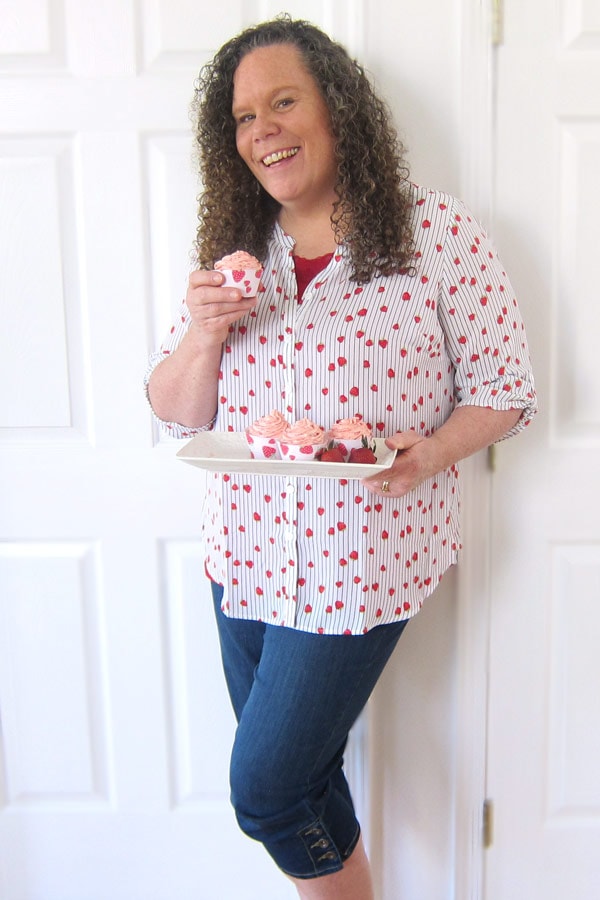 Beth Klosterboer, blogger at Hungry Happenings, showing off her Strawberry Cupcakes while wearing a strawberry top from Catherines