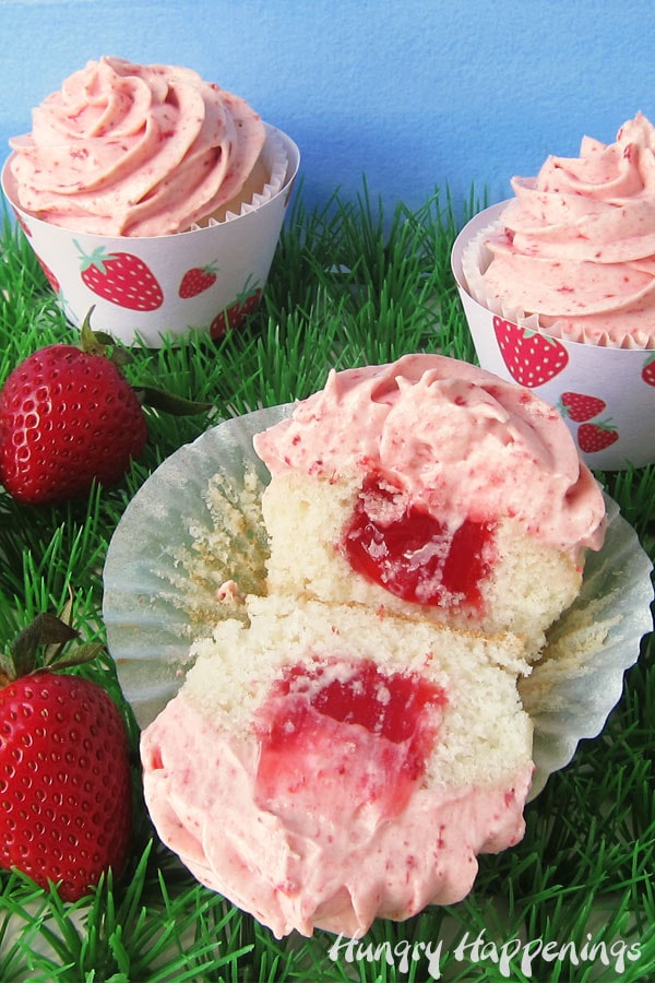 Strawberry Cupcake with one cut open showing the strawberry pie filling inside.