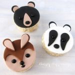 cute animal themed rice krispie treats including a black bear, a bunny, and a badger all decorated using fondant