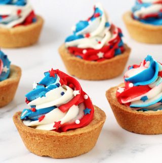 sugar cookie cups topped with a swirl of red white and blue frosting