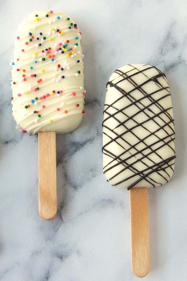 Cakesicles with rainbow sprinkles or dark chocolate drizzle.