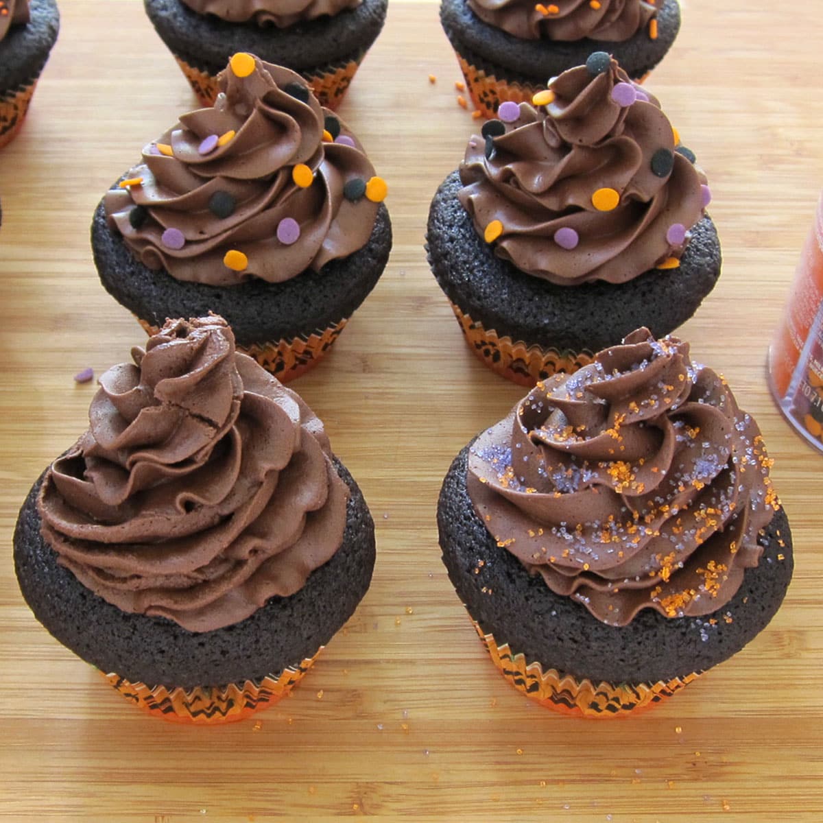 chocolate frosted cupcakes decorated with Halloween sprinkles. 