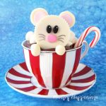 Top a hot chocolate cupcake with an adorable White Chocolate Reese's Cup Mouse then add a mini candy cane stirrer.