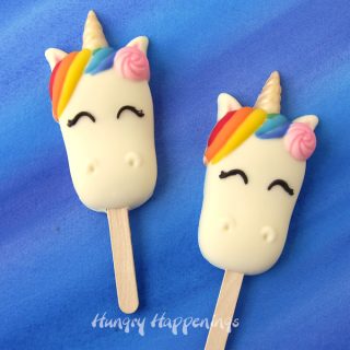 Colorful hand-painted white chocolate Unicorn Cakesicles filled with a blend of white cake and vanilla buttercream frosting.