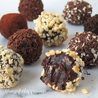 Delicious chocolate truffles coated in chopped cashews, shaved dark chocolate, cocoa powder, cookie crumbs, and a blend of dark and white chocolate shavings.