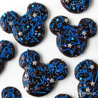 Mickey Mouse Galaxy Cookies - chocolate cookies topped with chocolate ganache and galaxy sprinkles.