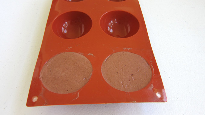 Chocolate Raspberry Mousse in a half-sphere silicone mold.