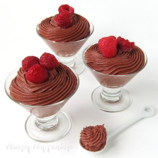 Chocolate Raspberry Mousse topped with raspberries served in clear dessert cups.