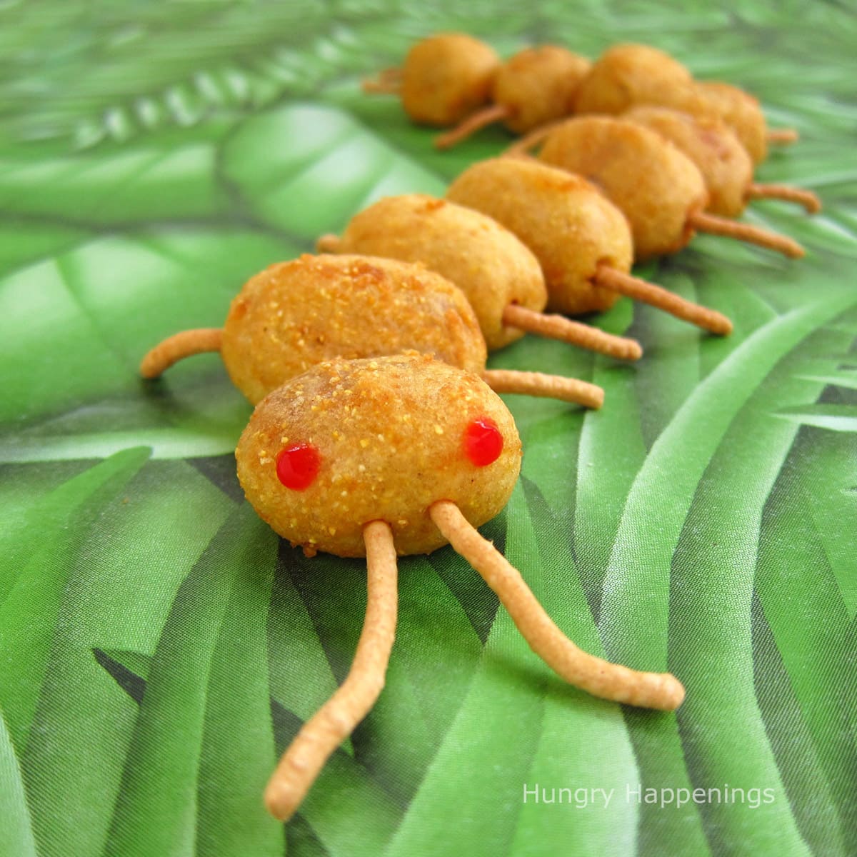 corn dog centipede made using mini corn dogs and chow mein noodles.