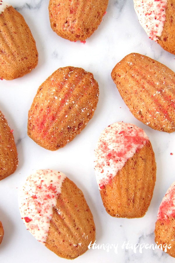 shell shaped madeleines filled with bits of freeze-dried strawberries with some dipped in white chocolate