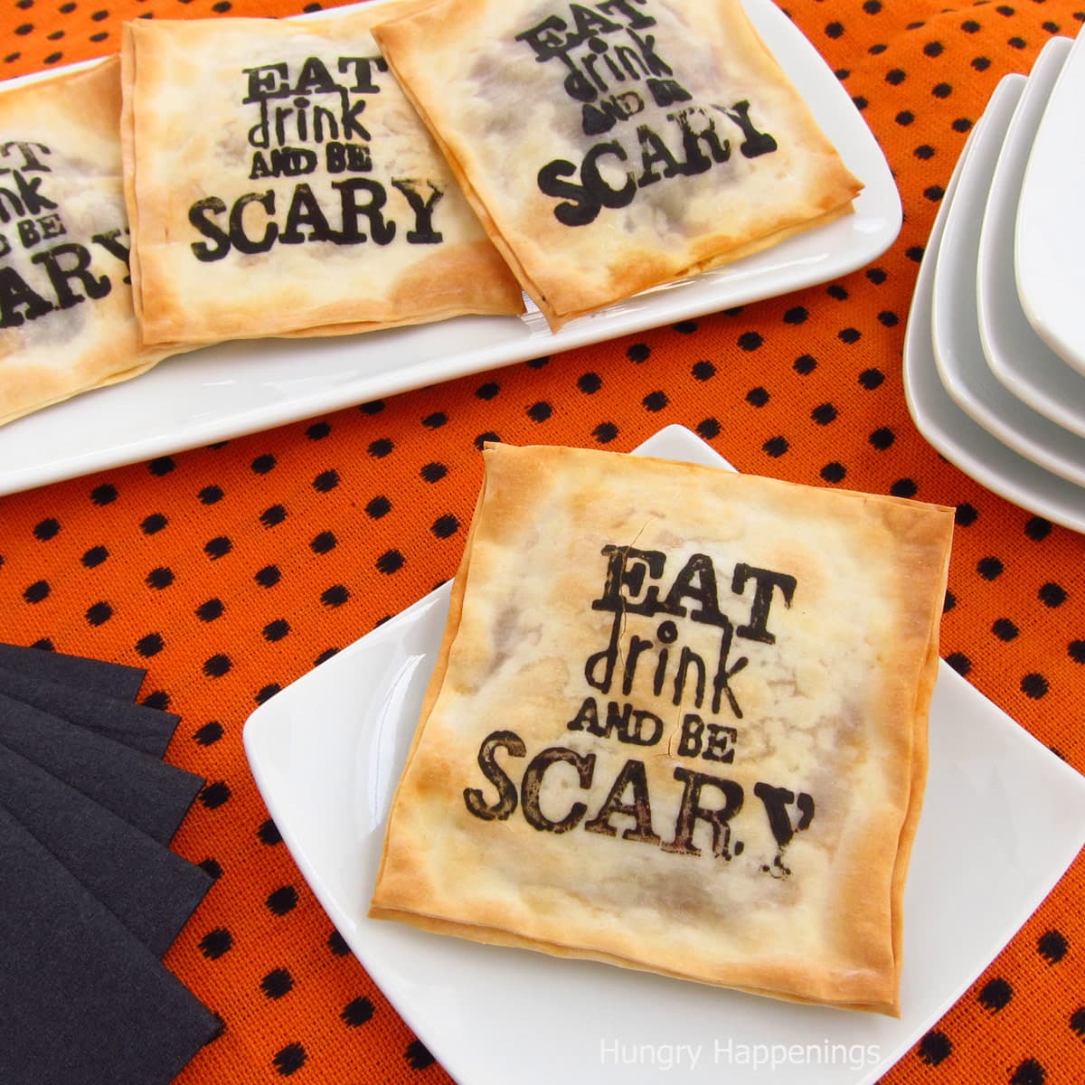 Halloween appetizers stamped with Eat, Drink, and Be Scary on a baked won ton filled with Madeira Mushrooms.