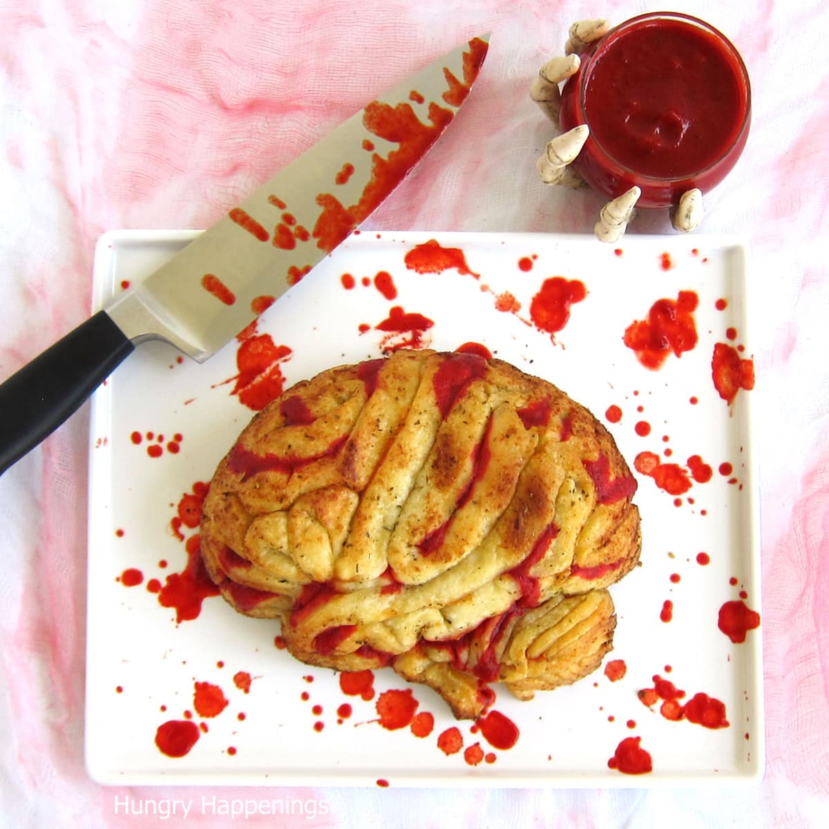 stuffed pizza brain served on a marinara blood-stained platter with a bloody knife.