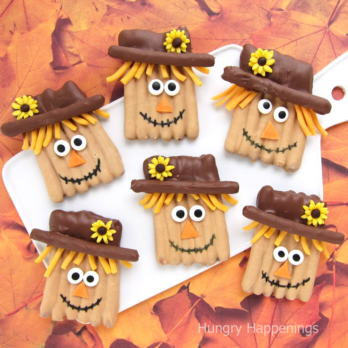 scarecrow pretzels dipped with chocolate and peanut butter coating.