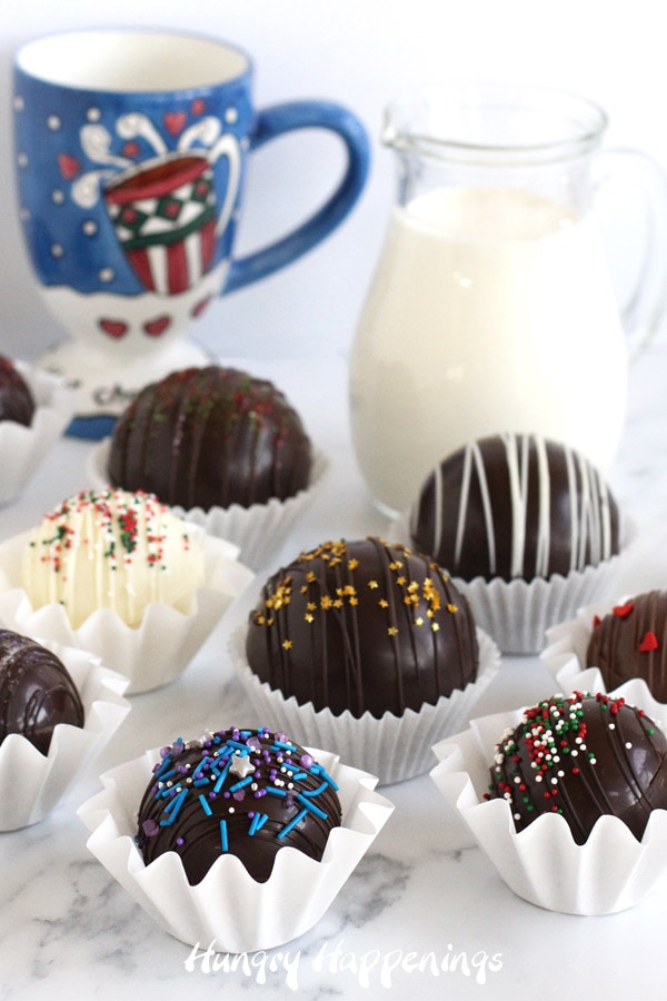 Fill a mug halfway with very hot milk. Then drop in a hot chocolate bomb and pour more hot milk over top. Allow the chocolate to melt then stir to make delicious chocolate chocolate. 