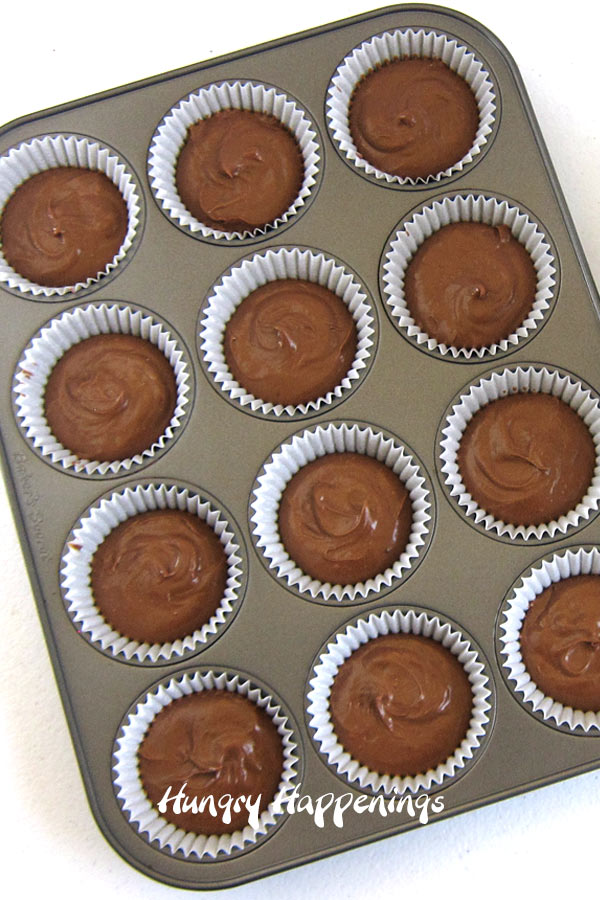 Fill the cupcake wrappers with the cookie crumb crusts and chocolate cheesecake filling.