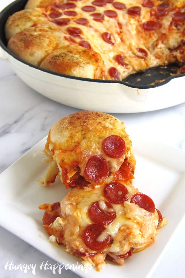Skillet pizza dip topped with mini pepperoni surrounded by cheese-filled pizza dough.
