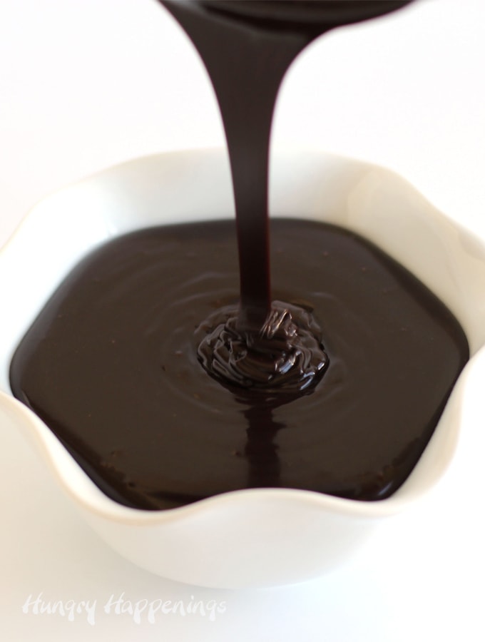 Pouring creamy and smooth chocolate ganache into a white bowl.
