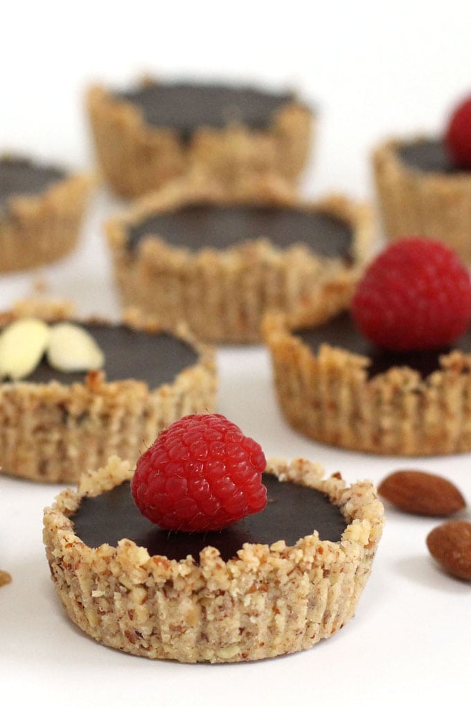 Mini chocolate tarts made with almond cookie crusts and almond milk chocolate ganache.