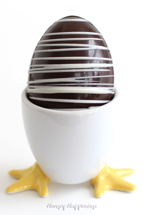 Hot chocolate bomb Easter eggs served in a hatching chick hard boiled egg holder. 
