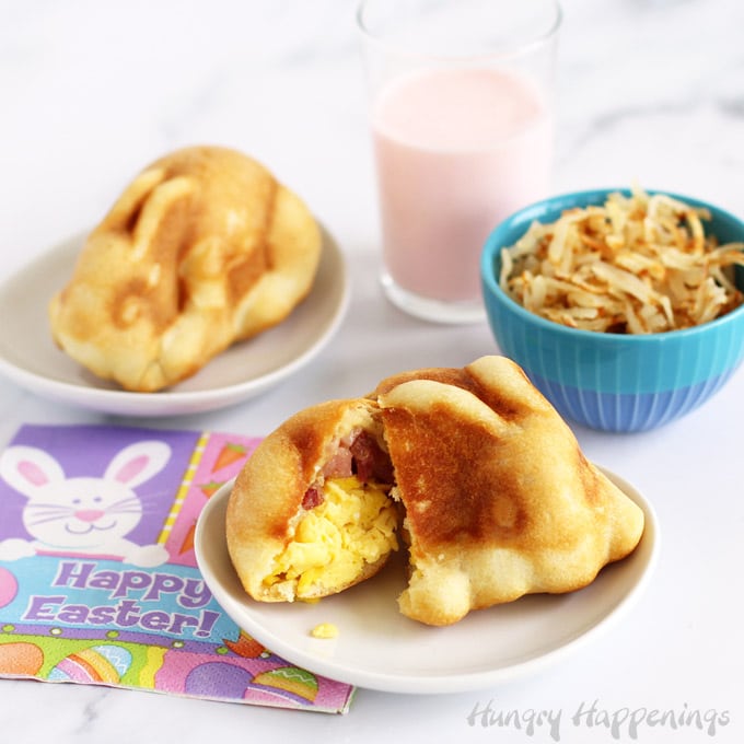 Easter breakfast pizza bunnies are filled with scrambled eggs, ham, and cheese and served with strawberry milk and hashbrowns.