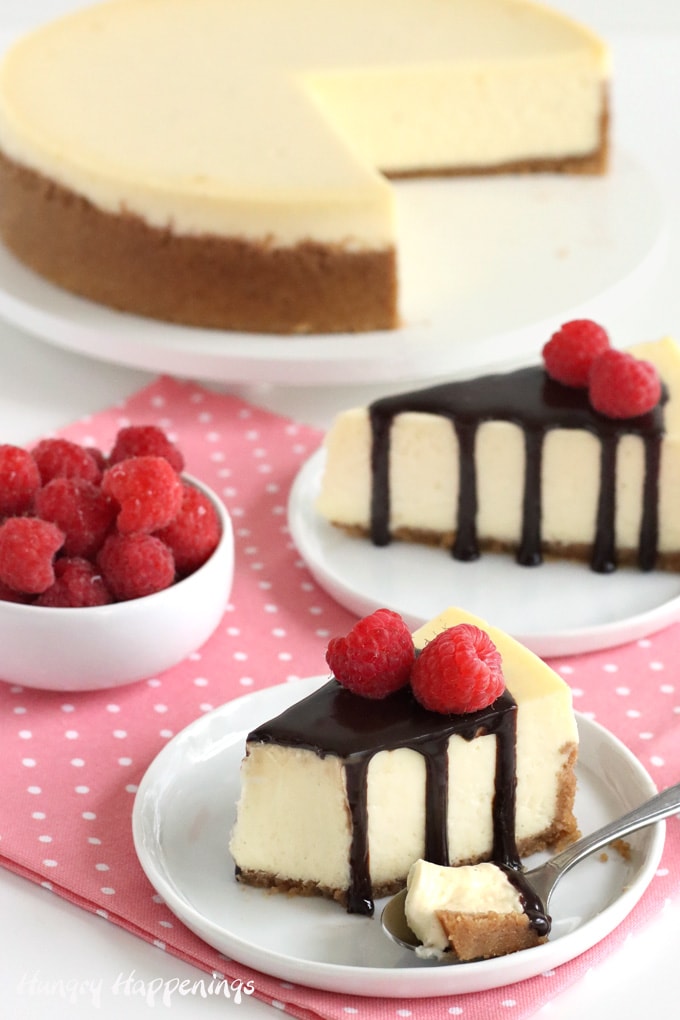 Classic cheesecake topped with chocolate ganache and fresh raspberries.