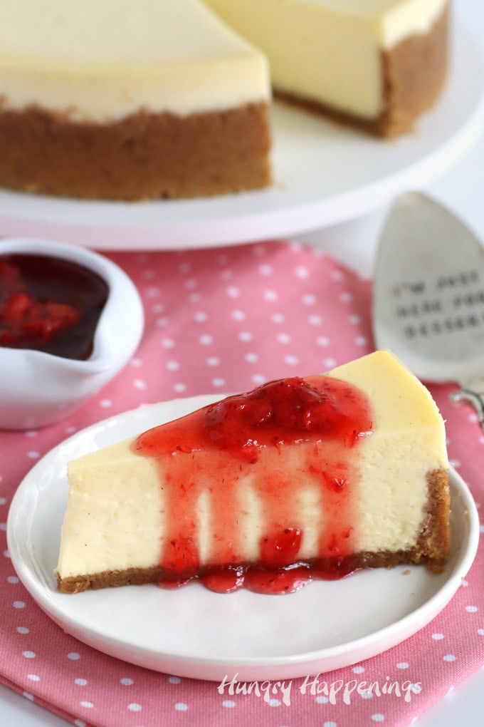Vanilla bean cheesecake topped with strawberry sauce. 