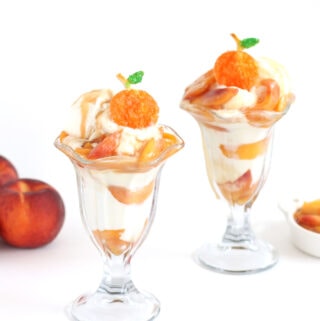 peach sundaes with vanilla ice cream topped with caramelized peaches and pie crust peaches