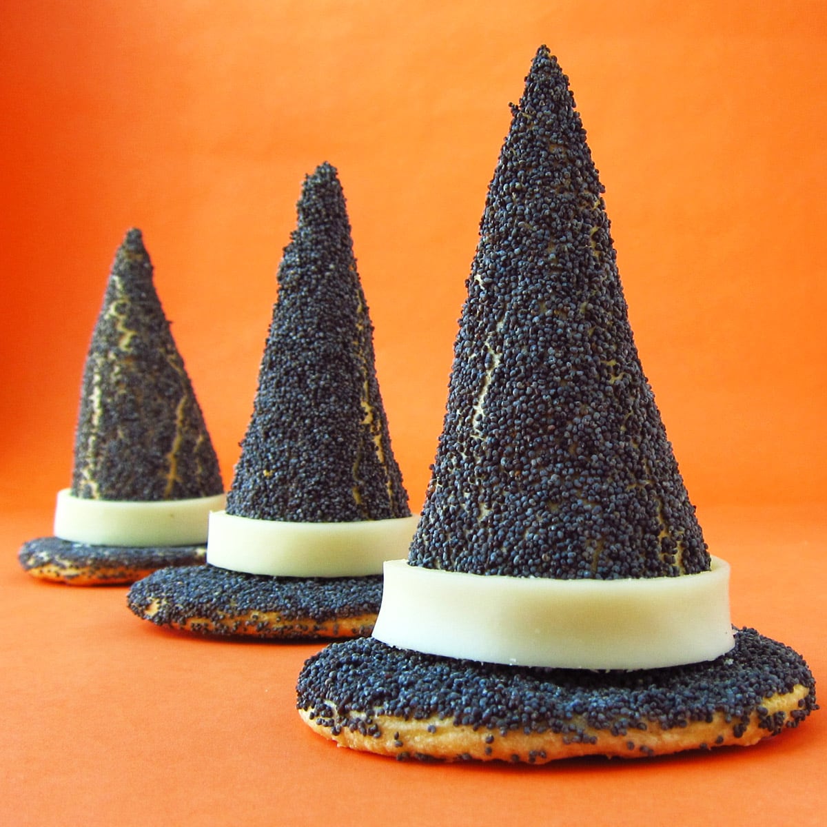 Halloween appetizers poppy seed-coated witch hat crescent rolls.