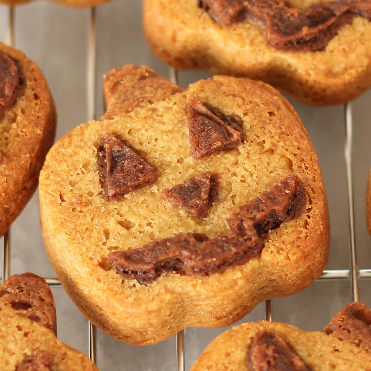 peanut butter cookie pumpkins with chocolate Jack-O-Lantern faces. 