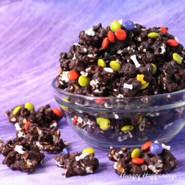 Dark chocolate Halloween popcorn topped with Halloween M&M's and bone sprinkles.