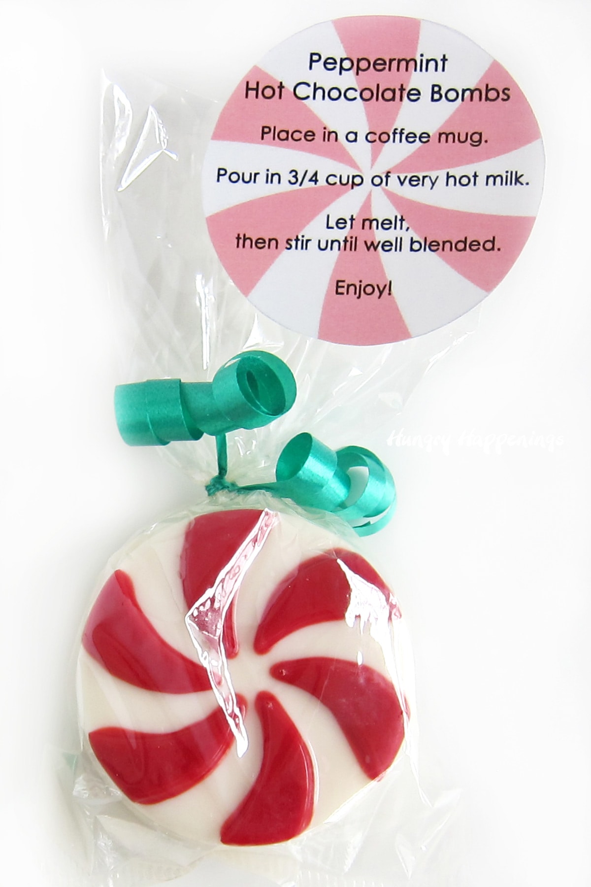 Peppermint hot chocolate bombs packaged in clear cellophane bags with a printable instructions tag.