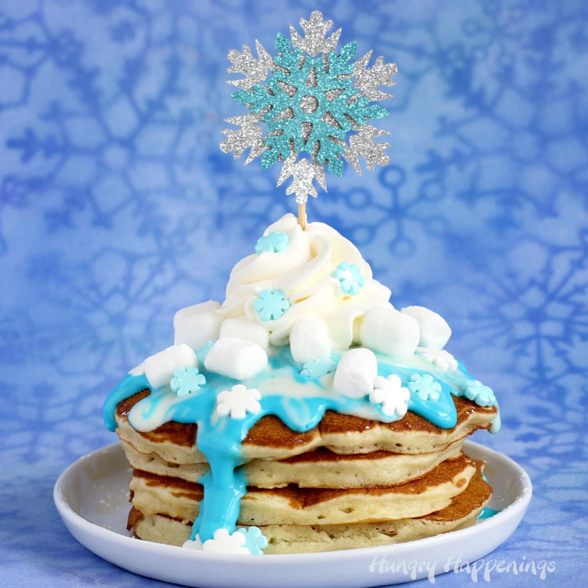 Disney's Frozen Pancakes topped with candy snowflakes, whipped cream, and marshmallows.