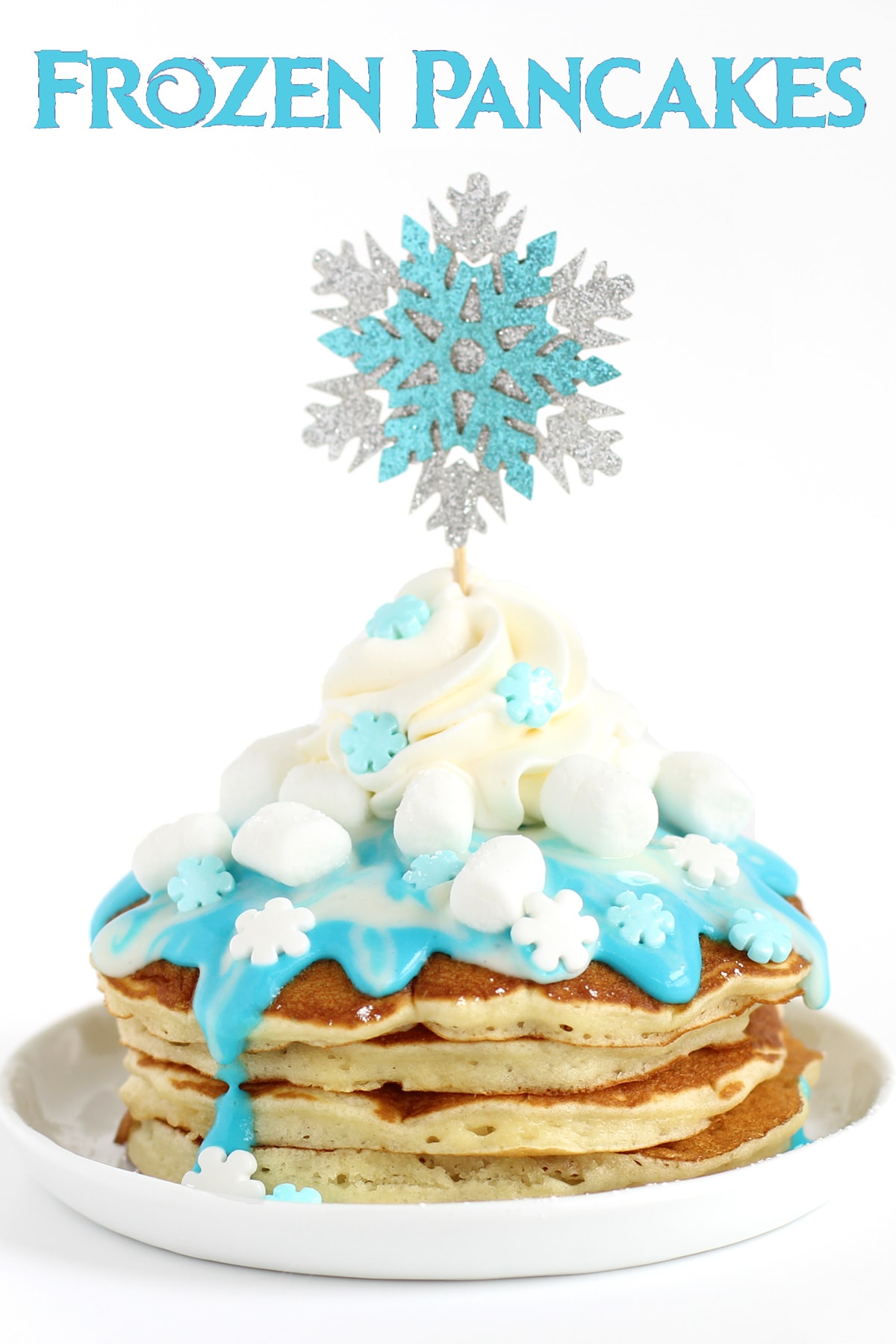 Frozen Pancakes - buttermilk pancakes topped with candy snowflakes, marshmallows, whipped cream, and blue and white cream cheese icing.