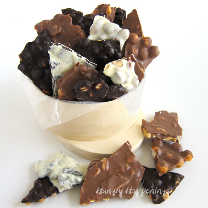 Homemade chocolate bark filled with caramel, almonds, peanuts, cashews, OREO Cookies, pretzels, toffee bits, and more packaged in a wooden box. 