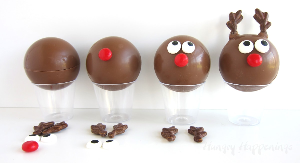 Attach a red candy nose, two candy eyes, and two candy antlers to milk chocolate bombs to create reindeer.